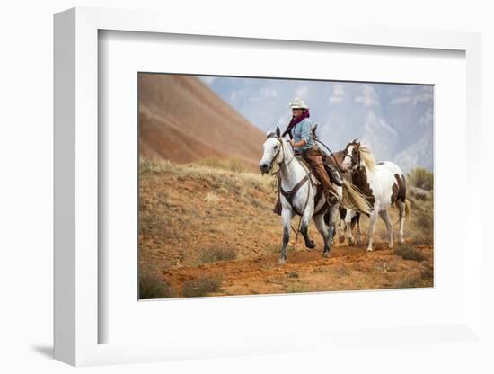 Cowgirl at Full Gallop with Horses in Tow-Terry Eggers-Framed Photographic Print