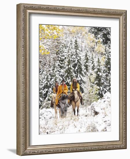 Cowgirls and Cowboy Riding in Autumn Aspens with a Fresh Snowfall-Terry Eggers-Framed Photographic Print