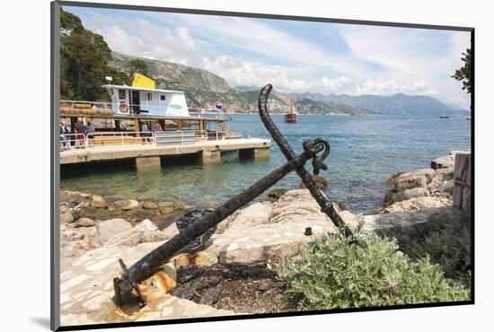 Croatia, Dubrovnik. Ferry dock Lokrum Island framed by old anchor.-Trish Drury-Mounted Photographic Print