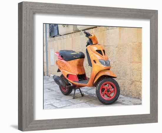 Croatia, Hvar. Bright orange vespa bike in the town of Hvar. (Editorial Use Only)-Julie Eggers-Framed Photographic Print