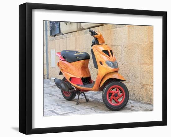 Croatia, Hvar. Bright orange vespa bike in the town of Hvar. (Editorial Use Only)-Julie Eggers-Framed Photographic Print