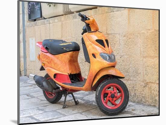 Croatia, Hvar. Bright orange vespa bike in the town of Hvar. (Editorial Use Only)-Julie Eggers-Mounted Photographic Print