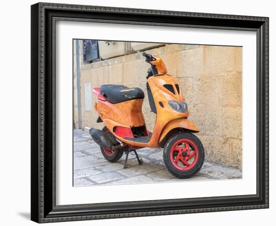 Croatia, Hvar. Bright orange vespa bike in the town of Hvar. (Editorial Use Only)-Julie Eggers-Framed Photographic Print