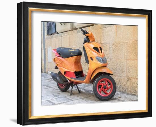 Croatia, Hvar. Bright orange vespa bike in the town of Hvar. (Editorial Use Only)-Julie Eggers-Framed Photographic Print