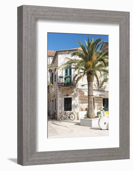 Croatia, Hvar Island, Stari Grad. Uncrowded. Bicycle parked at cafe.-Trish Drury-Framed Photographic Print