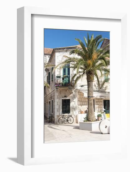 Croatia, Hvar Island, Stari Grad. Uncrowded. Bicycle parked at cafe.-Trish Drury-Framed Photographic Print