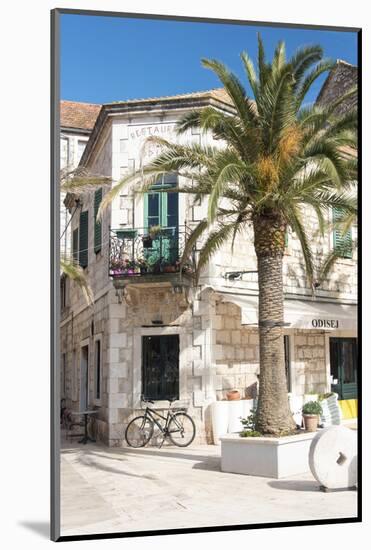 Croatia, Hvar Island, Stari Grad. Uncrowded. Bicycle parked at cafe.-Trish Drury-Mounted Photographic Print