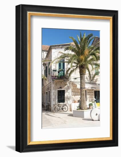 Croatia, Hvar Island, Stari Grad. Uncrowded. Bicycle parked at cafe.-Trish Drury-Framed Photographic Print