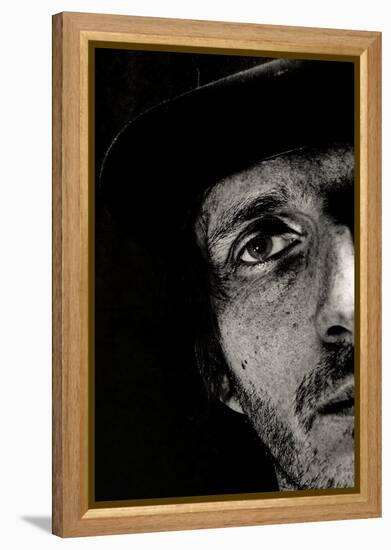 Cropped Portrait of a Man with Hat Starring into the Camera-Torsten Richter-Framed Premier Image Canvas
