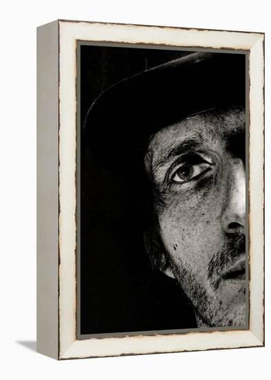 Cropped Portrait of a Man with Hat Starring into the Camera-Torsten Richter-Framed Premier Image Canvas