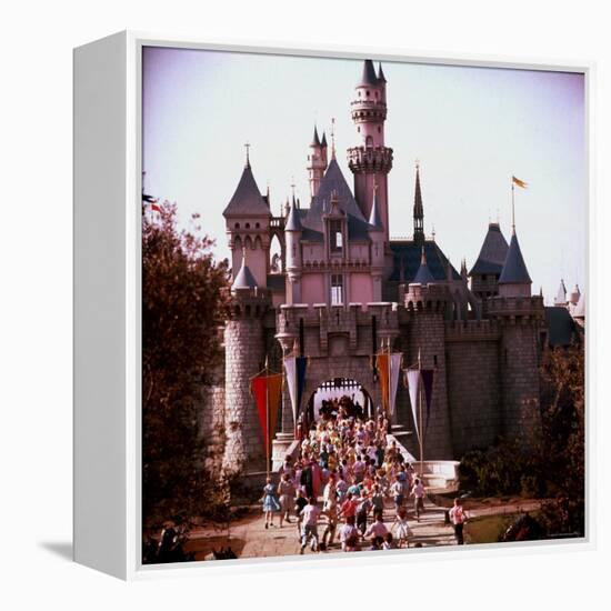 Crowds Walking Through Gate of Sleeping Beauty's Castle at Walt Disney's Theme Park, Disneyland-Allan Grant-Framed Premier Image Canvas