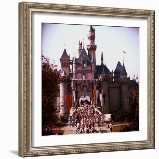 Crowds Walking Through Gate of Sleeping Beauty's Castle at Walt Disney's Theme Park, Disneyland-Allan Grant-Framed Photographic Print