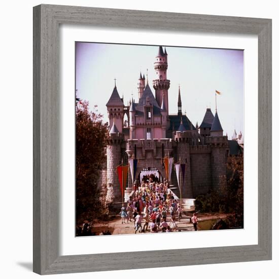 Crowds Walking Through Gate of Sleeping Beauty's Castle at Walt Disney's Theme Park, Disneyland-Allan Grant-Framed Photographic Print