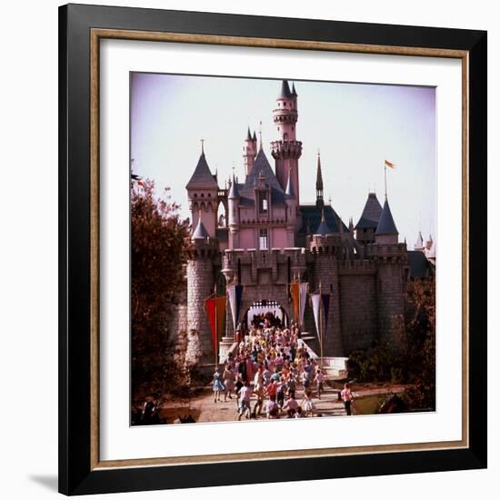Crowds Walking Through Gate of Sleeping Beauty's Castle at Walt Disney's Theme Park, Disneyland-Allan Grant-Framed Photographic Print