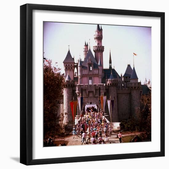 Crowds Walking Through Gate of Sleeping Beauty's Castle at Walt Disney's Theme Park, Disneyland-Allan Grant-Framed Photographic Print