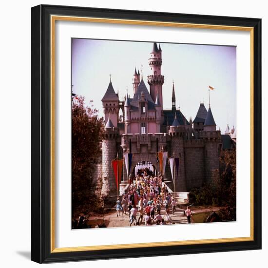 Crowds Walking Through Gate of Sleeping Beauty's Castle at Walt Disney's Theme Park, Disneyland-Allan Grant-Framed Photographic Print