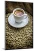 Cup of Espresso on a Sack with Unroasted Coffee Beans-Bernd Wittelsbach-Mounted Photographic Print