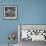 Curious Girl Looking at a Toy Chicken Head Toy by Charles Eames-Allan Grant-Framed Photographic Print displayed on a wall