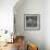 Curious Girl Looking at a Toy Chicken Head Toy by Charles Eames-Allan Grant-Framed Photographic Print displayed on a wall