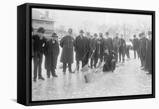 Curling in Central Park with Men Having Brooms at the Ready over the Ice.-null-Framed Stretched Canvas