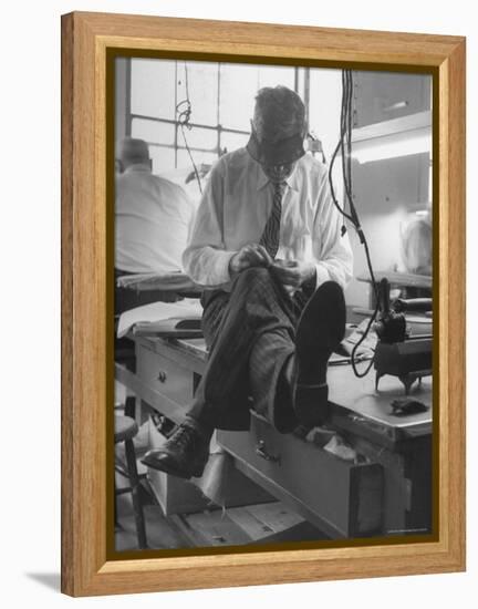 Custom Tailor Ernest Preedik Sitting on Table and Working in Factory-Ralph Morse-Framed Premier Image Canvas