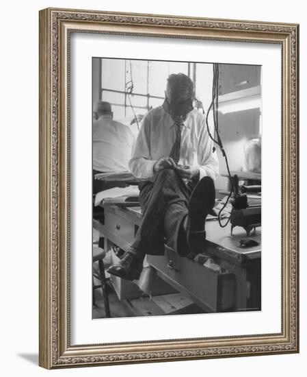 Custom Tailor Ernest Preedik Sitting on Table and Working in Factory-Ralph Morse-Framed Photographic Print