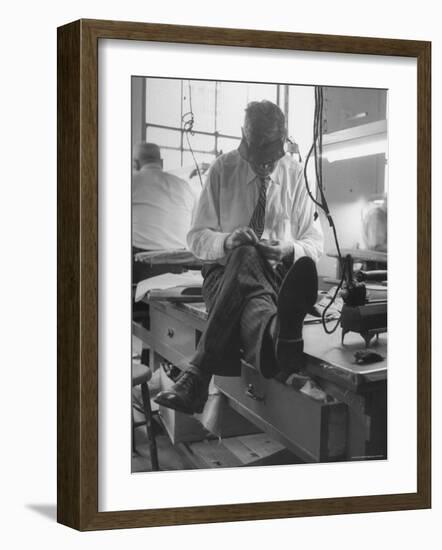 Custom Tailor Ernest Preedik Sitting on Table and Working in Factory-Ralph Morse-Framed Photographic Print