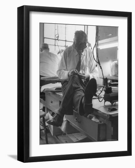 Custom Tailor Ernest Preedik Sitting on Table and Working in Factory-Ralph Morse-Framed Photographic Print