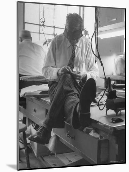 Custom Tailor Ernest Preedik Sitting on Table and Working in Factory-Ralph Morse-Mounted Photographic Print