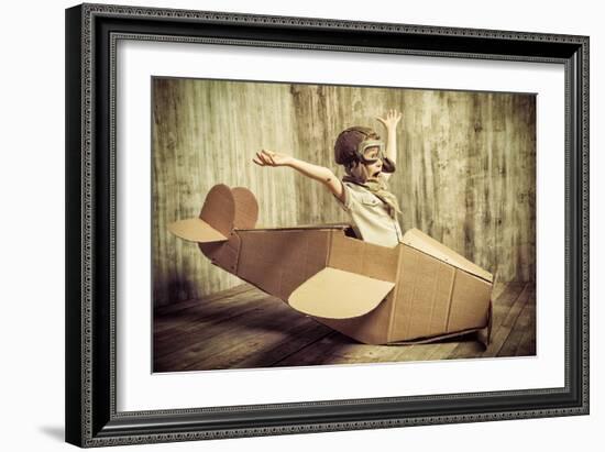 Cute Dreamer Boy Playing with a Cardboard Airplane. Childhood. Fantasy, Imagination. Retro Style.-prometeus-Framed Photographic Print