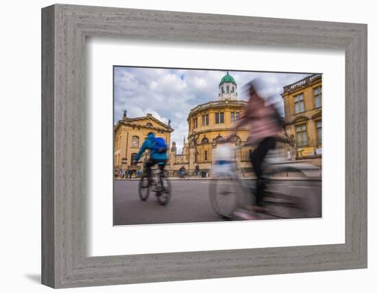 Cyclists Passing the Sheldonian Theatre, Oxford, Oxfordshire, England, United Kingdom, Europe-John Alexander-Framed Photographic Print