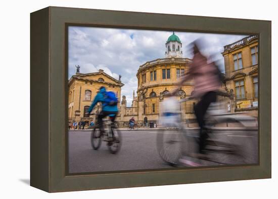 Cyclists Passing the Sheldonian Theatre, Oxford, Oxfordshire, England, United Kingdom, Europe-John Alexander-Framed Premier Image Canvas