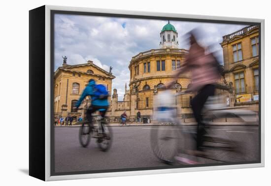 Cyclists Passing the Sheldonian Theatre, Oxford, Oxfordshire, England, United Kingdom, Europe-John Alexander-Framed Premier Image Canvas