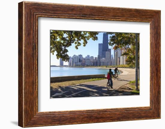 Cyclists Riding Along Lake Michigan Shore with the Chicago Skyline Beyond, Chicago, Illinois, USA-Amanda Hall-Framed Photographic Print