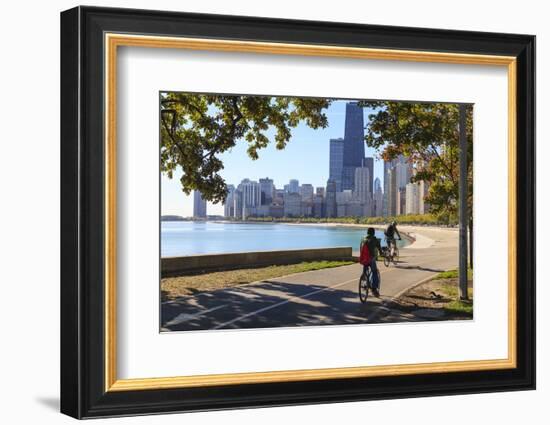 Cyclists Riding Along Lake Michigan Shore with the Chicago Skyline Beyond, Chicago, Illinois, USA-Amanda Hall-Framed Photographic Print