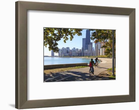 Cyclists Riding Along Lake Michigan Shore with the Chicago Skyline Beyond, Chicago, Illinois, USA-Amanda Hall-Framed Photographic Print