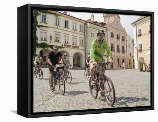 Cyclists Riding Through Namesti in Town of Mikulov, Brnensko Region-Richard Nebesky-Framed Premier Image Canvas