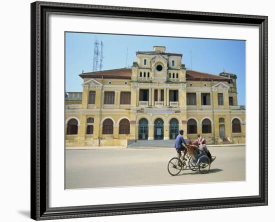 Cyclo Passing the Old Post Office in Phnom Penh in Cambodia, Indochina, Southeast Asia-Tim Hall-Framed Photographic Print