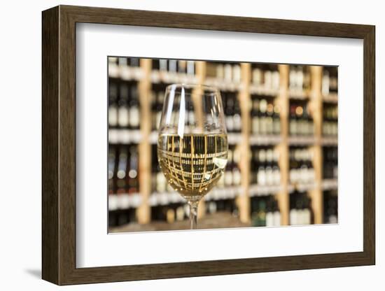 Czech Republic, Prague. Glass of White Wine Reflects Wine Bottle Shelf-Jaynes Gallery-Framed Photographic Print