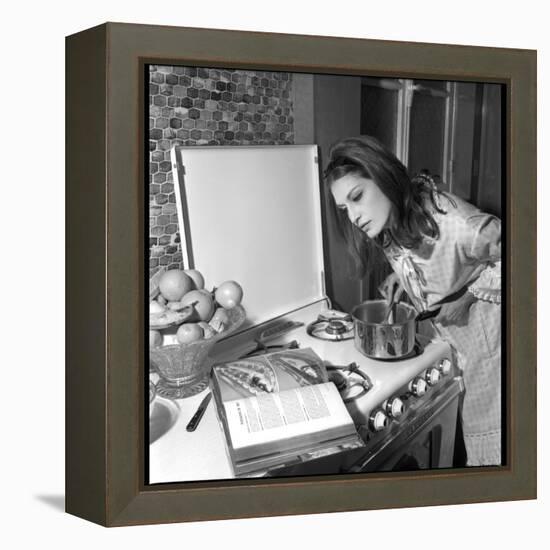 Dalida Ccooking in Her Kitchen-Marcel Begoin-Framed Premier Image Canvas