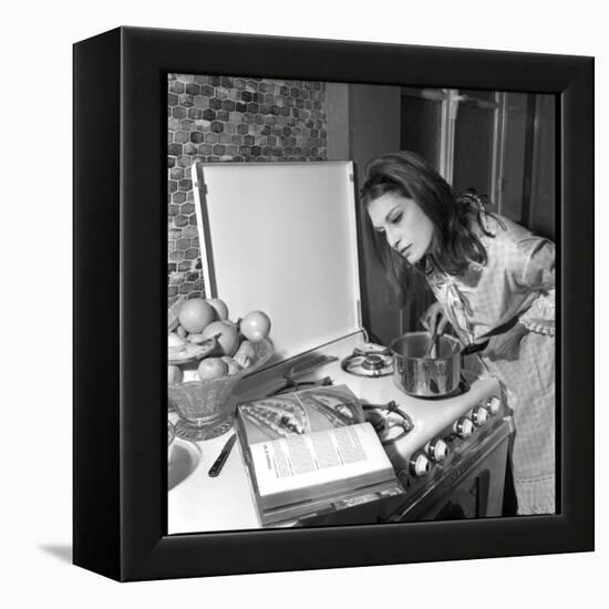 Dalida Ccooking in Her Kitchen-Marcel Begoin-Framed Premier Image Canvas