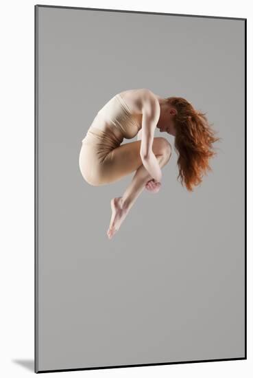 Dancer in Mid-Air with Arms around Knees-null-Mounted Photo