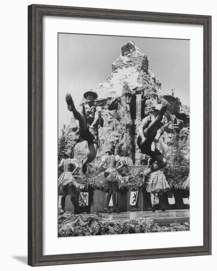 Dancers Do Matterhorn Act in Front of Artificial Slope at Disneyland-Ralph Crane-Framed Photographic Print