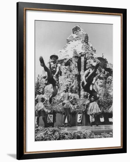 Dancers Do Matterhorn Act in Front of Artificial Slope at Disneyland-Ralph Crane-Framed Photographic Print