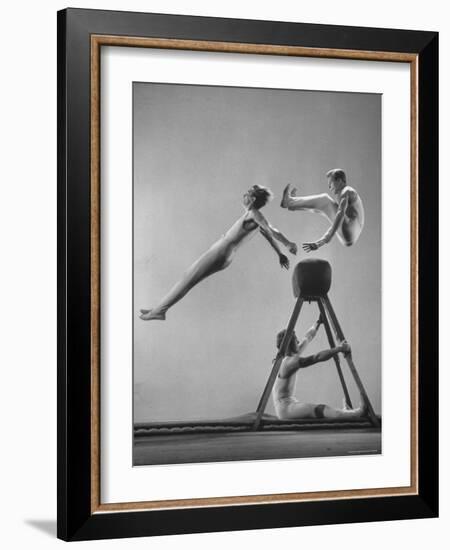 Danish Gymnasts Erik Hansen Followed by John Thomsen Do High Thief Jump as Team Member Braces Buck-Gjon Mili-Framed Photographic Print