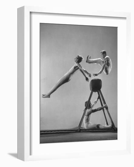 Danish Gymnasts Erik Hansen Followed by John Thomsen Do High Thief Jump as Team Member Braces Buck-Gjon Mili-Framed Photographic Print