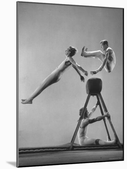 Danish Gymnasts Erik Hansen Followed by John Thomsen Do High Thief Jump as Team Member Braces Buck-Gjon Mili-Mounted Photographic Print