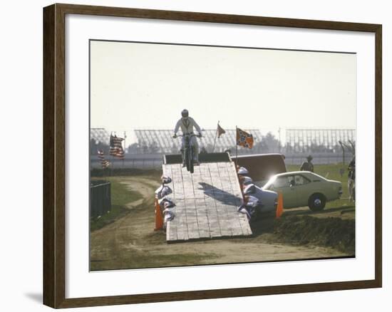 Daredevil Motorcyclist Evel Knievel Rising on Platform During Performance of Stunt-null-Framed Premium Photographic Print