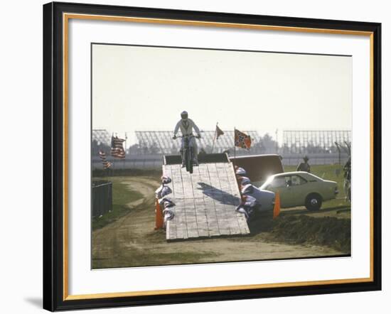 Daredevil Motorcyclist Evel Knievel Rising on Platform During Performance of Stunt-null-Framed Premium Photographic Print