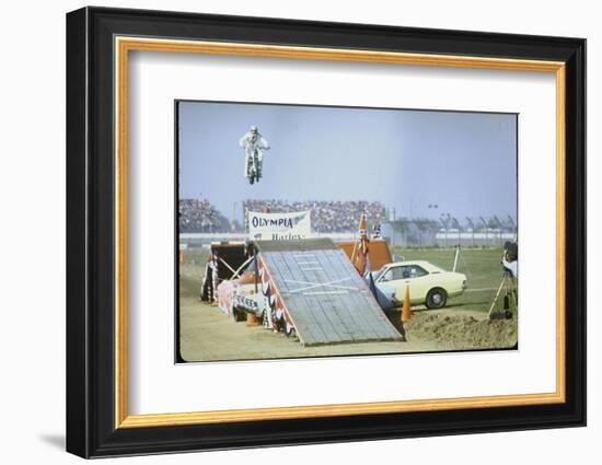 Daredevil Motorcyclist Evel Knievel Rising Very High Off Platform During Performance of a Stunt-Bill Eppridge-Framed Photographic Print